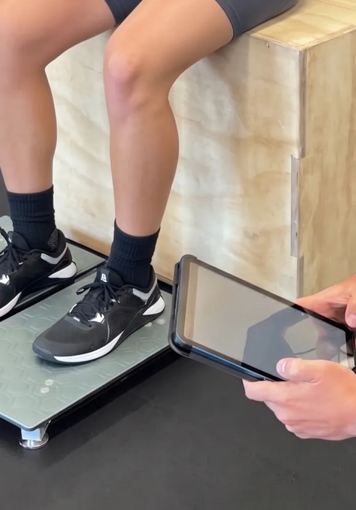 VALD ForceDecks screen displaying Limb Symmetry Index and plantar flexion force data during Achilles tendon rehab assessment.