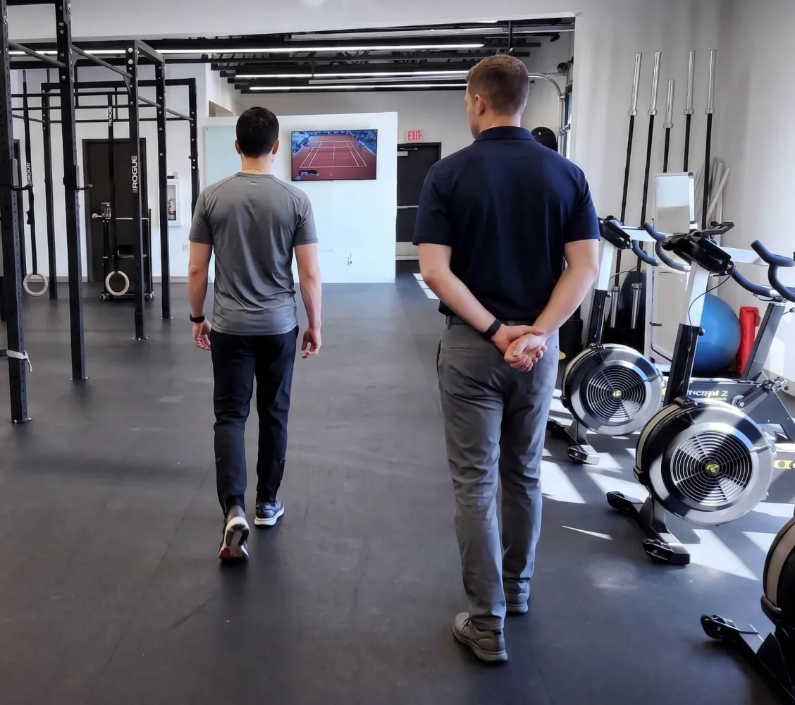 Post-surgical Achilles patient performing supervised walk-run intervals during graduated running reconditioning at PhysioFIT in Bend, Oregon.