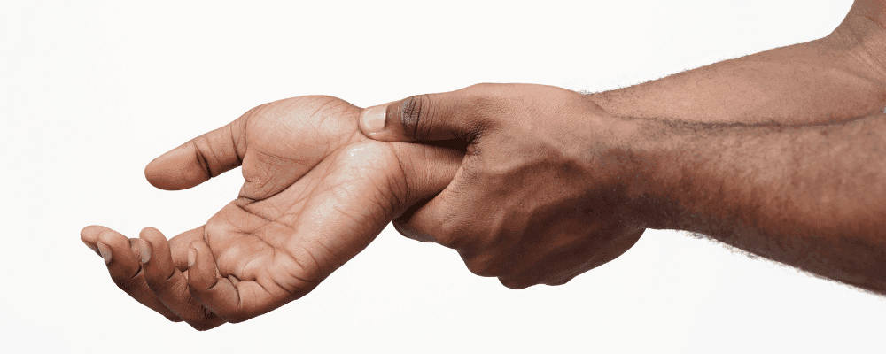 Man holding his wrist.