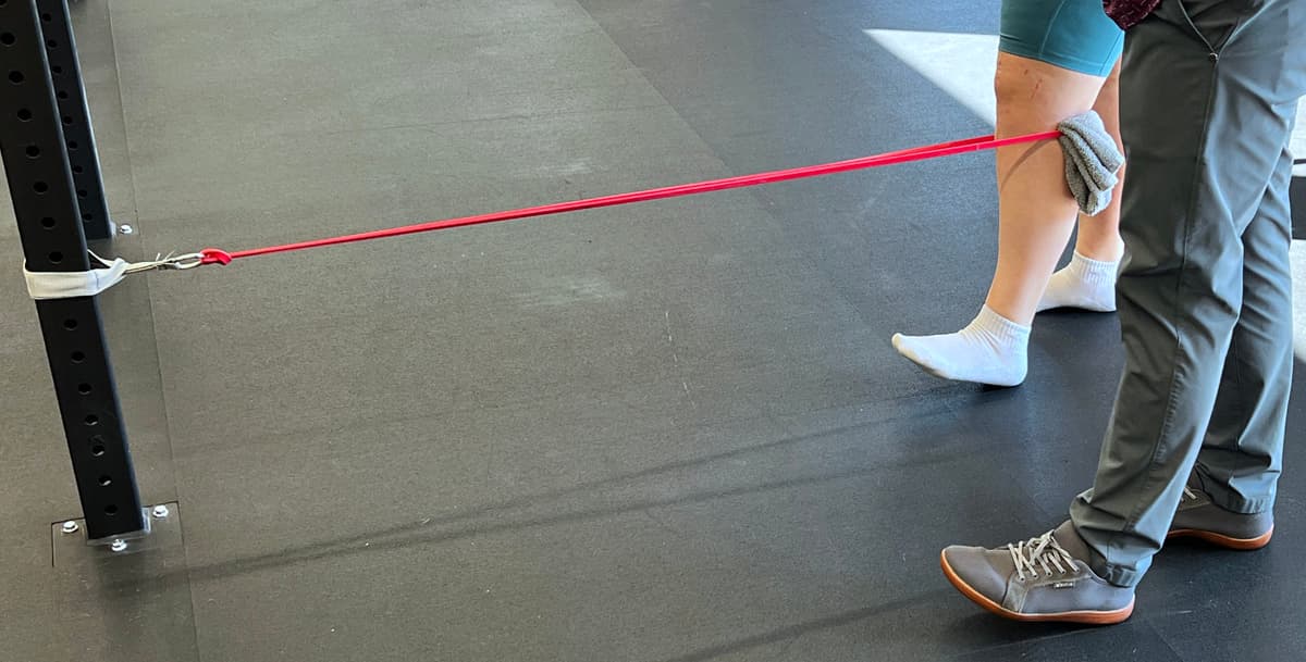 Patient performing strength training exercise during ACL rehabilitation