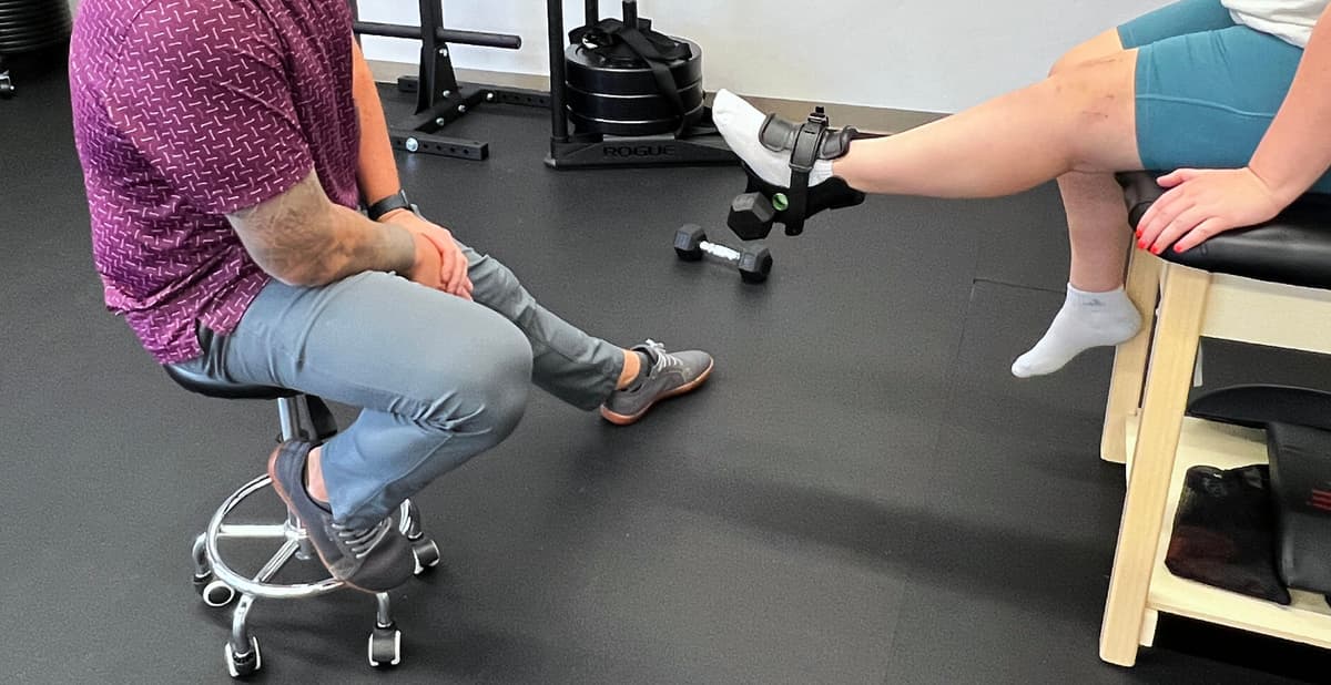 Physical therapist providing one-on-one ACL rehabilitation session