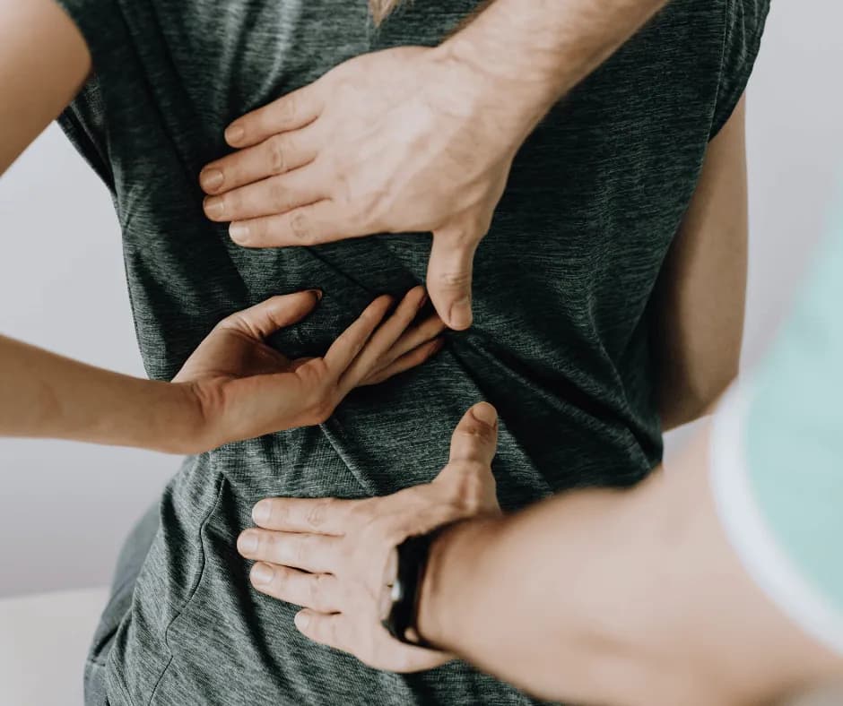 Common back pain symptoms treated with physical therapy at PhysioFIT