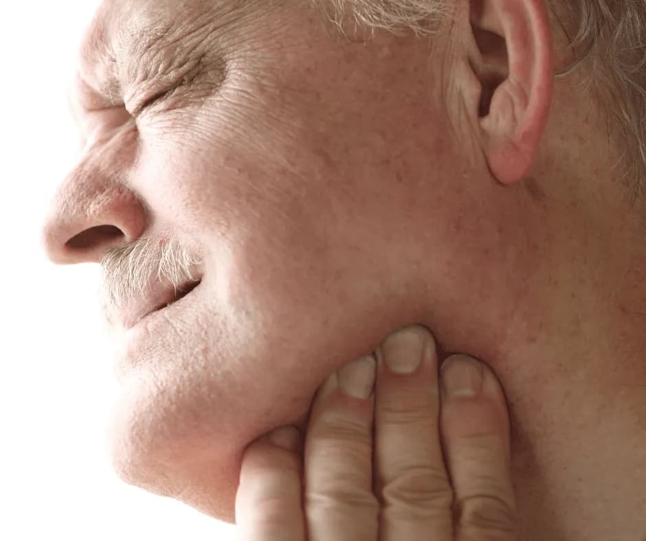A doctor of physical therapy assessing a patient's jaw for TMJ pain in Bend, Oregon
